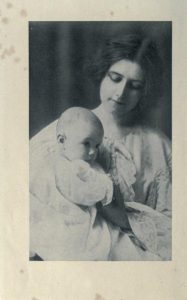 Black and white photograph or drawing of young woman holding an infant