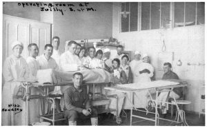 Operating room at Juilly, France in 1918 with Surgical Team #50, friends and Miss Perry Handley. UCSF Tales and Traditions, Volume VIII, Base Hospital 30 staff, WWI.