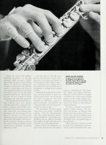 Black and white photograph of the fingers of a flautist holding her instrument; there are thin metal rings on the pinky and ring fingers of her right hand, pertaining to a mobility treatment she is undergoing, discussed in the article.