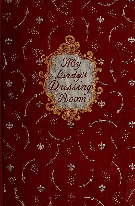 Red, silver, and gold cover of book with embossed sprays, dots, and fleur-de-lis; in the center is an elaborate panel reading "My Lady's Dressing Room" in fancy script.